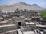 213 Kagbeni Houses And Ruined Fort From Kagbeni Gompas ROof The houses of Kagbeni and the ruins of the Kagbeni ancient fort are visible from the roof of the Kagbeni Gompa. The mountain on the far right is Yakawa Kang (6482m, also spelled Yakgawa), a rocky peak to the north of Thorung La.